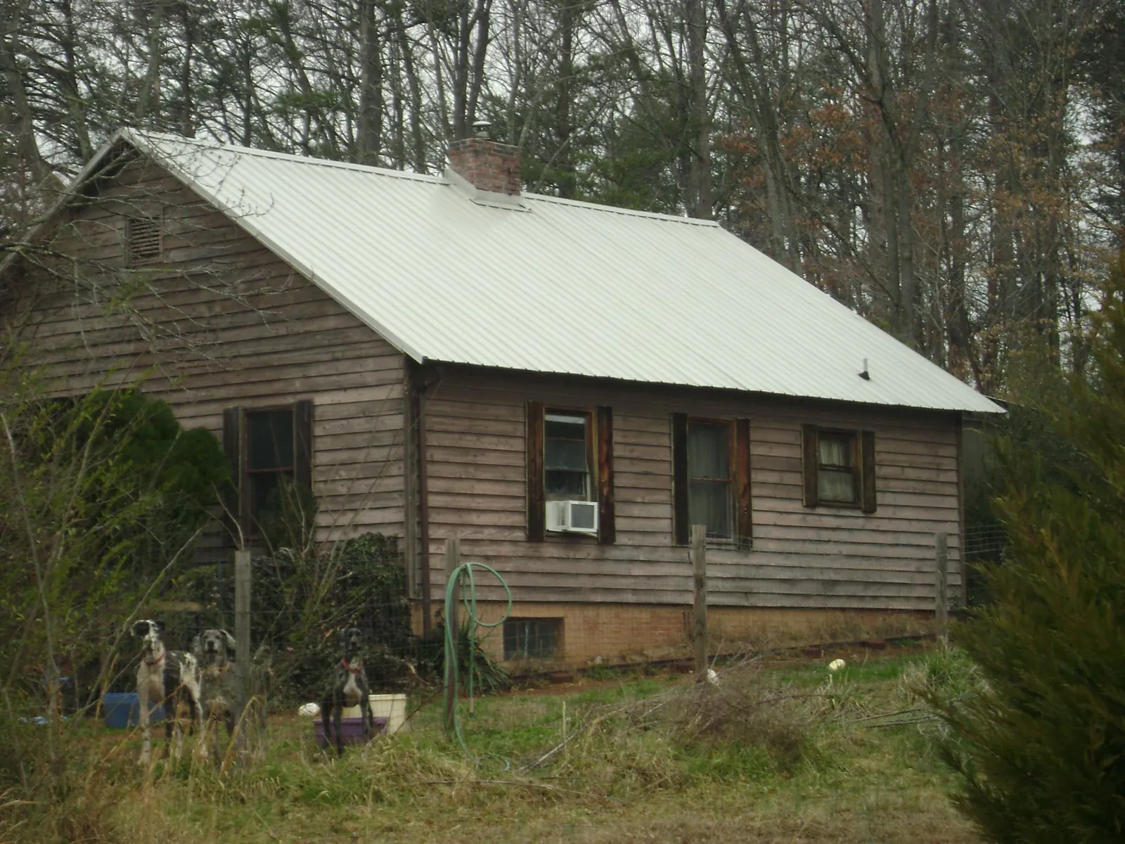 White metal roof on an old wood sided farmhouse, from a Metal Roof Installation job in Virginia City